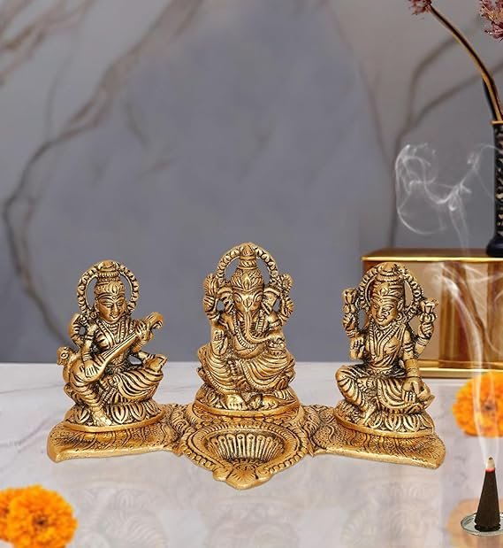 Amazon Brand - Umi Metal Ganesha Lakshmi and Saraswati Idol Metal Sculpture Seated On Peacock Throne Golden Height 4.0 Inches Width 7.5 Inches Medium
